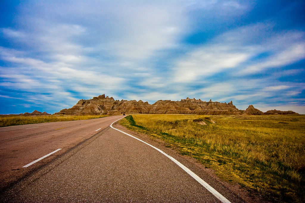 Long empty road stretching through a barren desert landscape