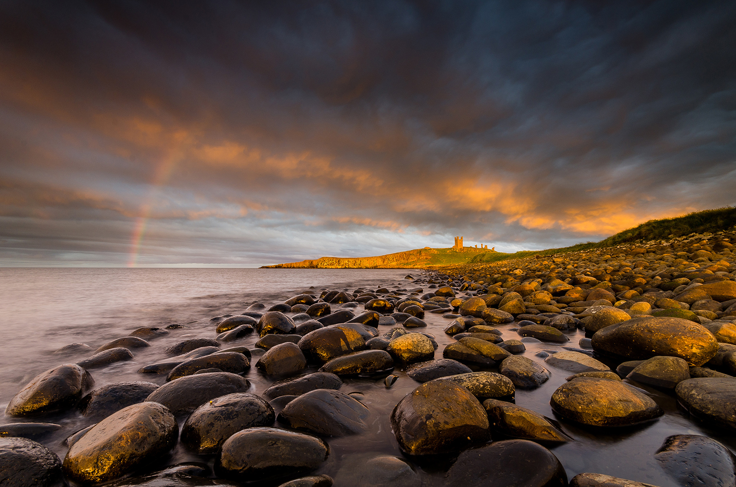 Rocky beach with scattered stones and gentle ocean waves